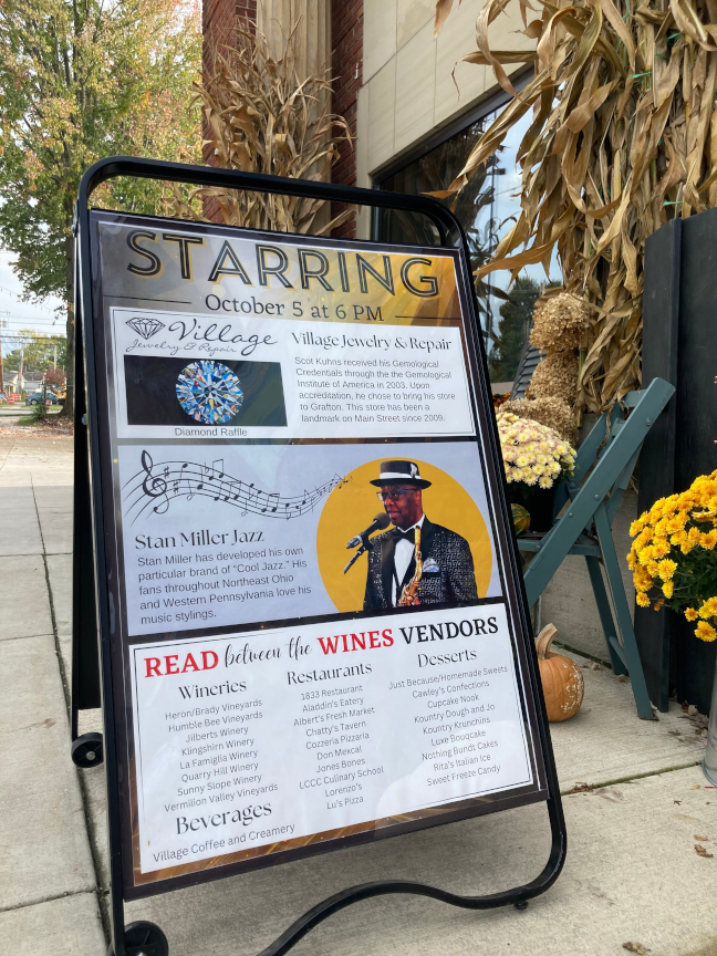 Les Miller played saxophone during Read Between the Wines, and a Diamond Raffle was also sponsored by Village Jewelry. This poster in the picture shows all the details.